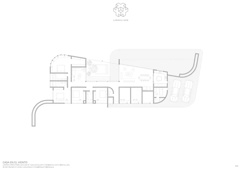 Floor plan drawing showing curved room layout with courtyards and parking area