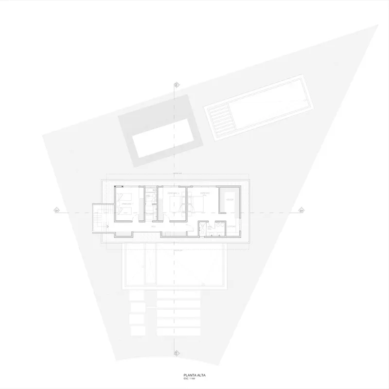 Upper level floor plan drawing showing bedroom layout and central bathroom with triangular site boundary