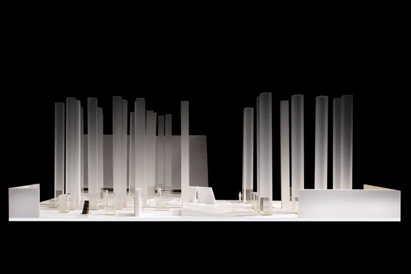 Physical model showing vertical tower volumes rising from a horizontal base against a black background