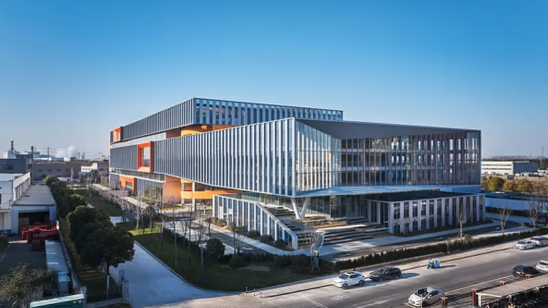 Aerial view of the stacked volumes with vertical fin facade and white branching columns below