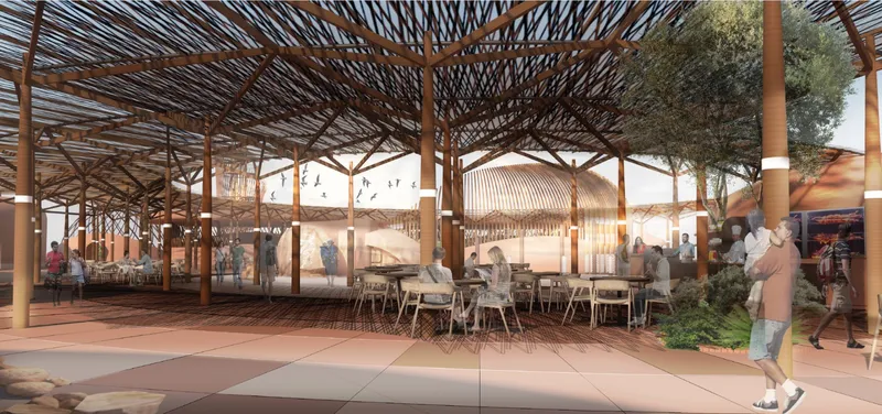 Covered outdoor dining area under branching timber canopy with tables and visitors at dusk