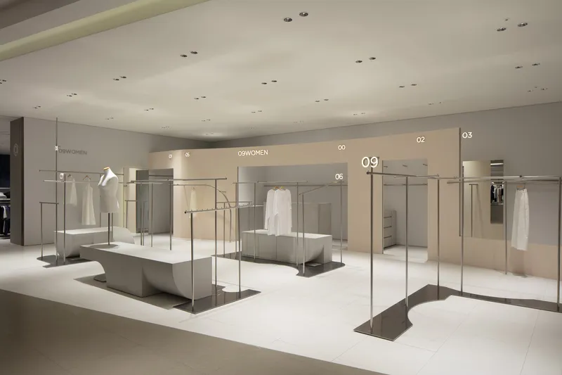 Retail floor with glass-enclosed display platforms and numbered zones under recessed ceiling lighting