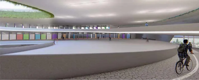 Interior ramp spiraling upward past colorful display panels with a cyclist in motion