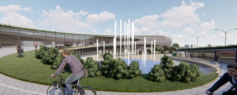 Aerial rendering of the landscaped plaza with fountain jets and cyclists on the surrounding path