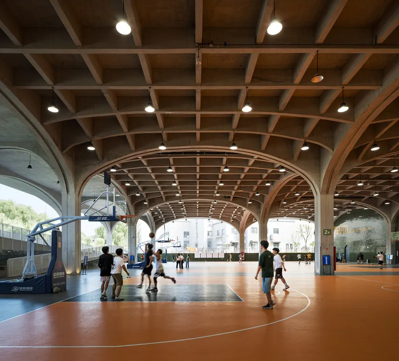 Players on orange court surface beneath coffered timber vault supported by concrete arches