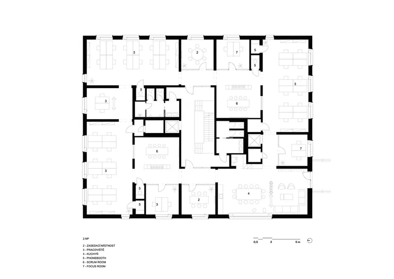 Floor plan drawing showing workspace clusters and conference rooms around a central circulation core