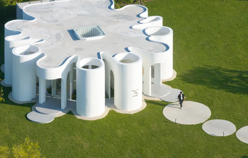 Aerial view of the undulating roofscape with circular stepping stones leading across the grass