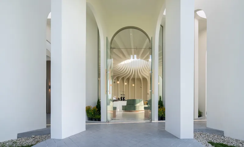 Arched entrance portal framing the view through to the interior with its ribbed ceiling and service counter