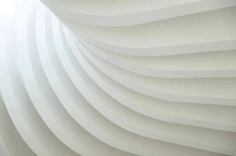 Close-up of the layered white ceiling ribs showing their concentric undulating profile