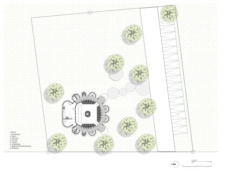 Site plan drawing showing the organic building form with surrounding trees and adjacent linear structure