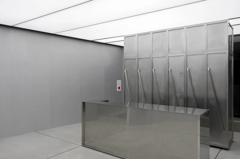 Steel storage cabinets with perforated metal base beneath linear skylights
