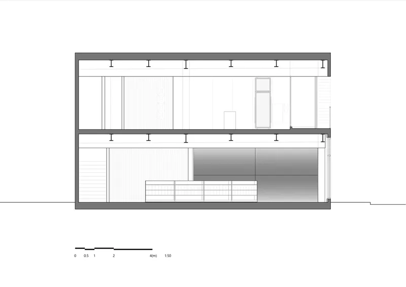 Section drawing showing two levels with exposed ceiling joists, stairs, and a central mezzanine opening