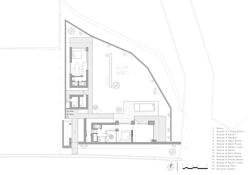 Ground floor plan showing two residential buildings around a central courtyard on an angled site
