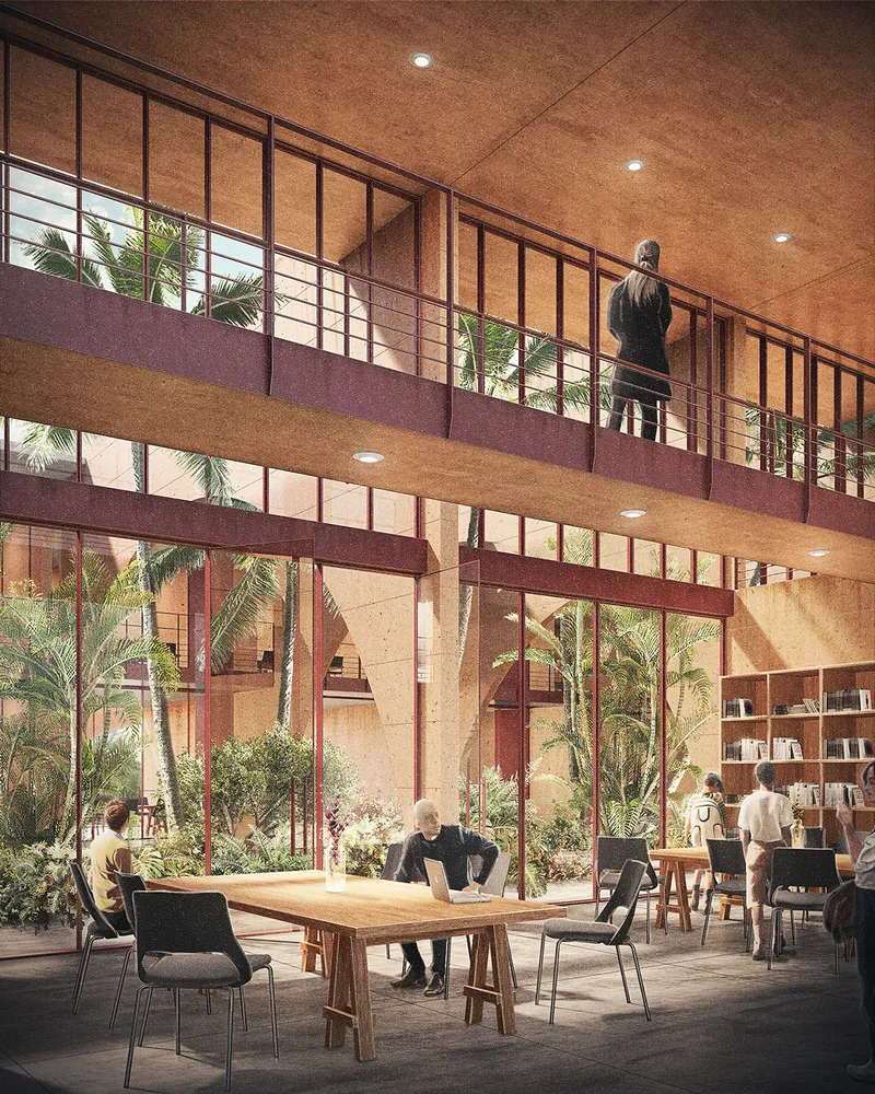 Double-height interior atrium with mezzanine balcony and planted courtyard visible through steel-framed glazing