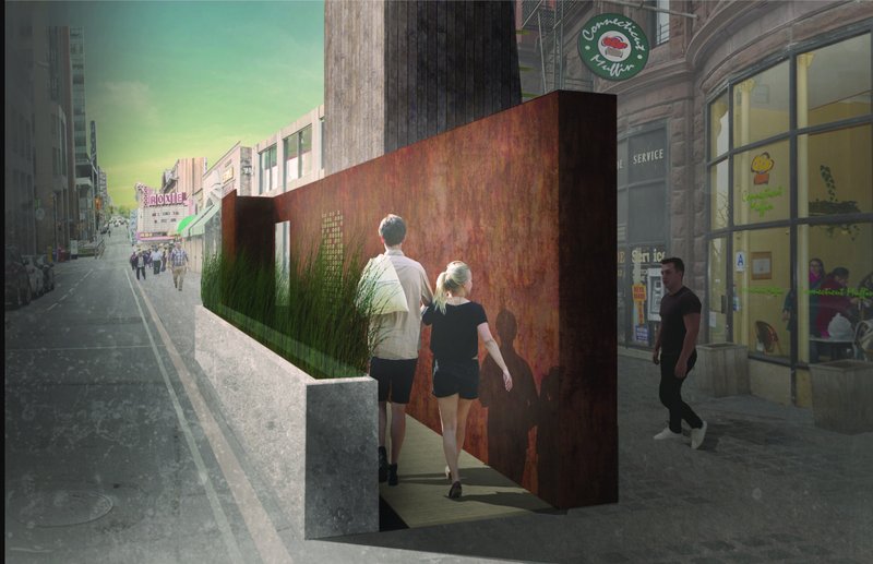 Streetside view through a rusted steel passageway with planted grasses and pedestrians walking along the sidewalk