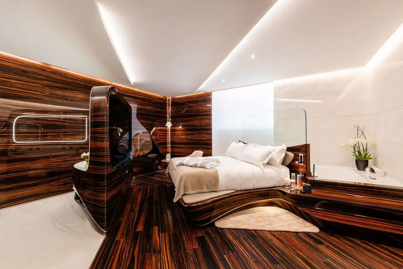 Bedroom corner showing the curved glass partition and striped wood wall with integrated shelving