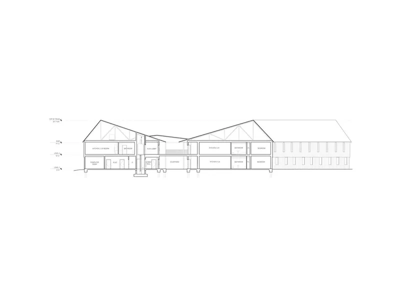 Section drawing revealing interior room layouts across multiple levels within connected gabled volumes