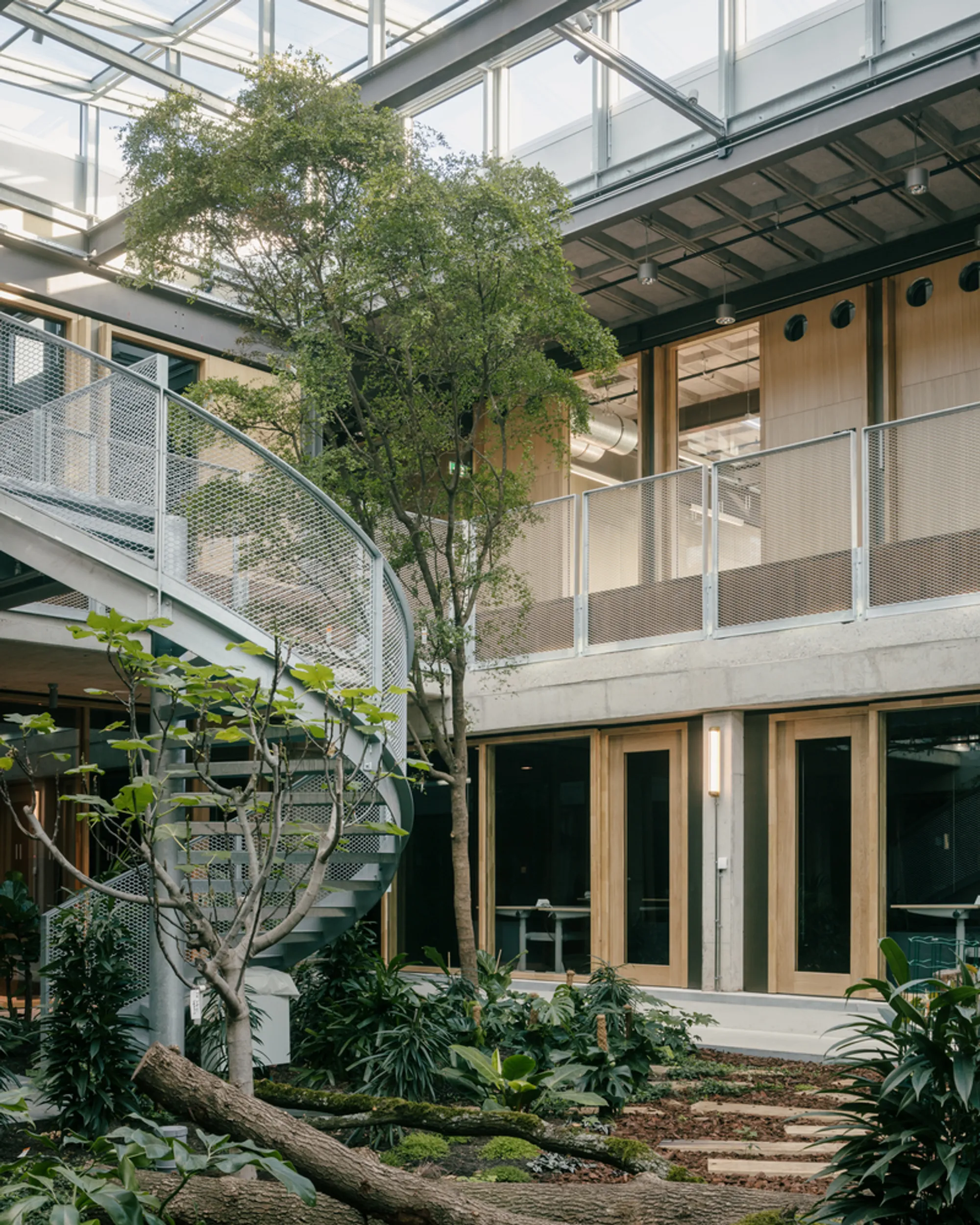 Civic Architects and VDNDP Carve Four Atria into a 220-Meter Brutalist Lab to Create ITC Enschede