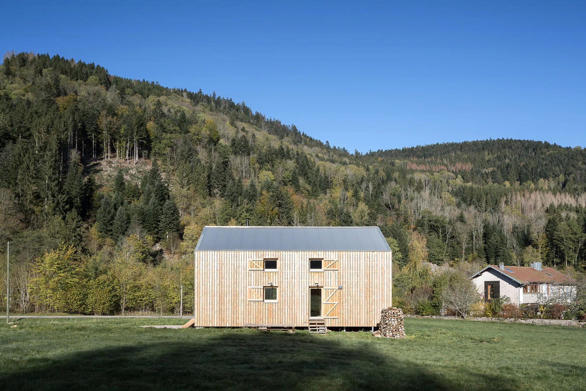 Studiolada Raises a Straw-Insulated Timber House on Granite Blocks in the Vosges Mountains