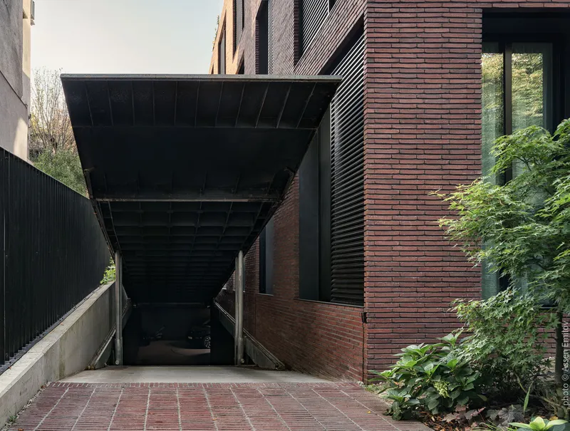 Underside view of canopy showing exposed structural bracing above the descending parking ramp