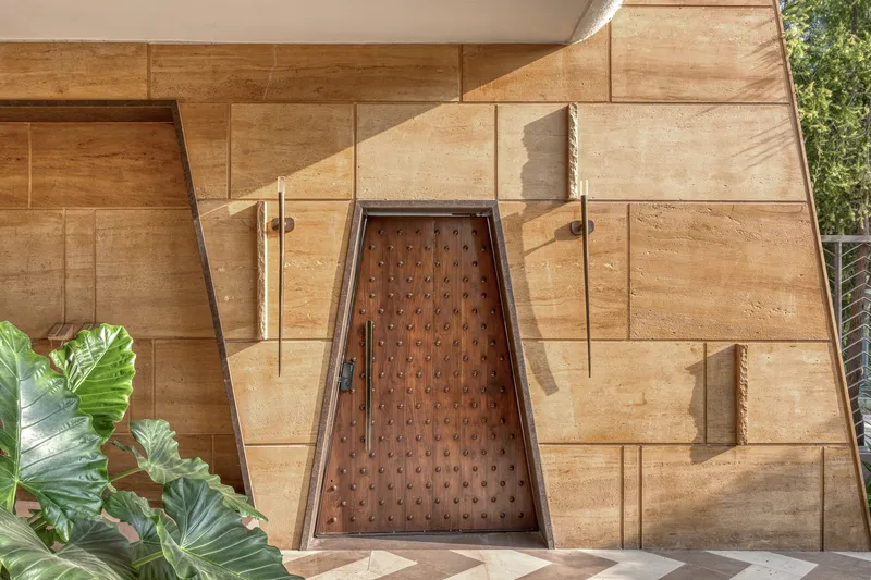 Overhead view of studded timber entry door set within stratified stone paving