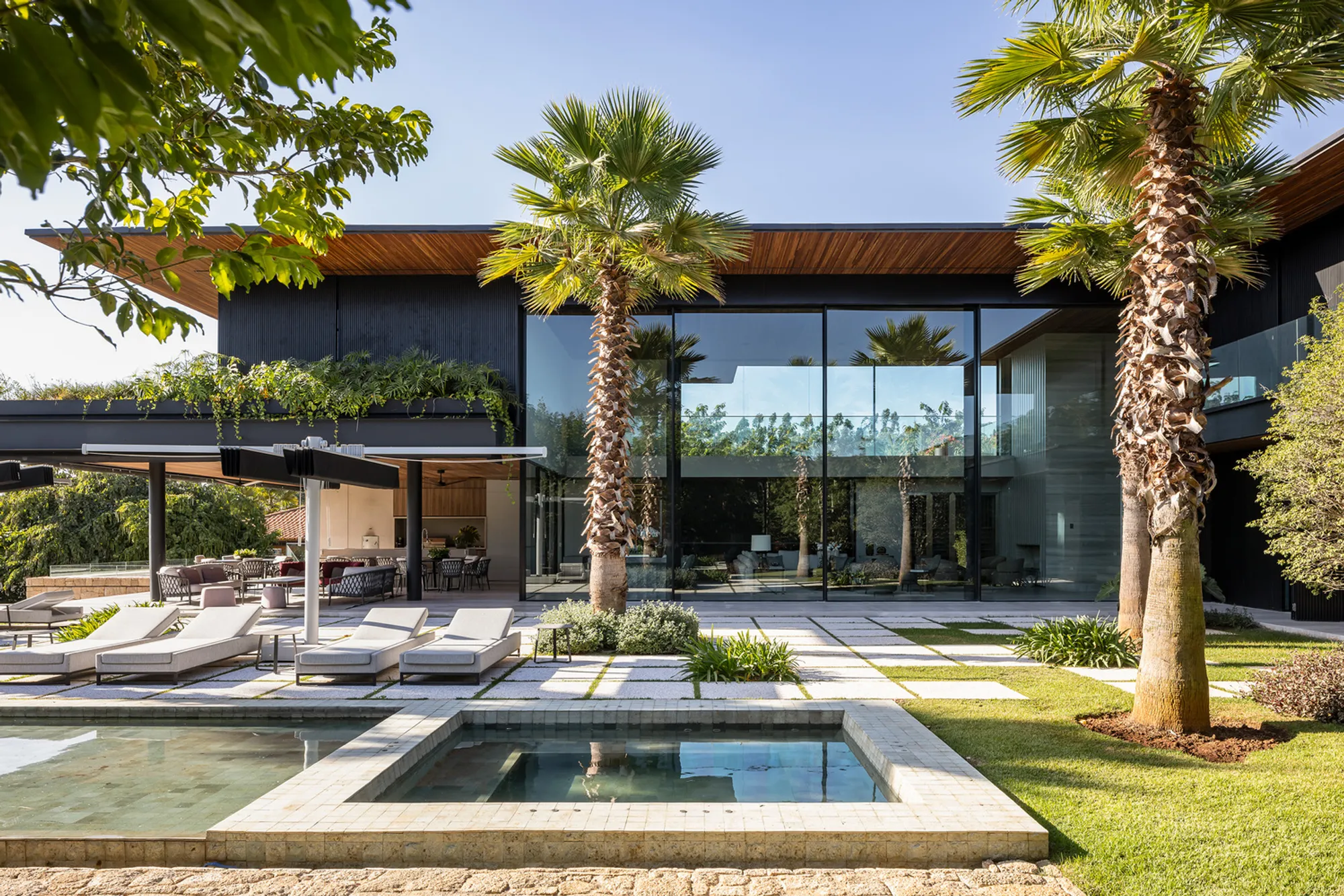 Padovani Arquitetos Nestles a Dark-Clad Lakeside Retreat Below Street Level in São Paulo