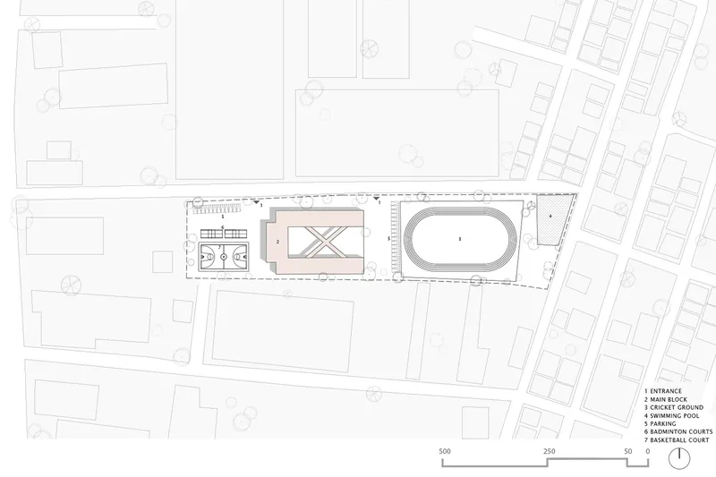 Site plan drawing showing a linear building with an oval sports field and rectangular courts along its length