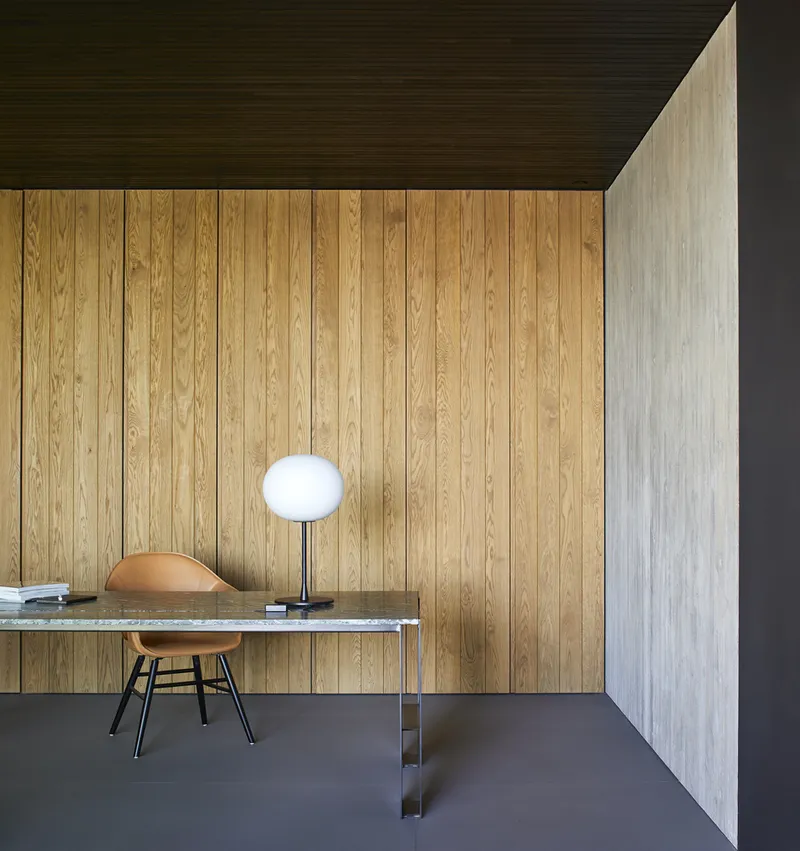 Workspace with vertical timber cladding and dark wood ceiling panels