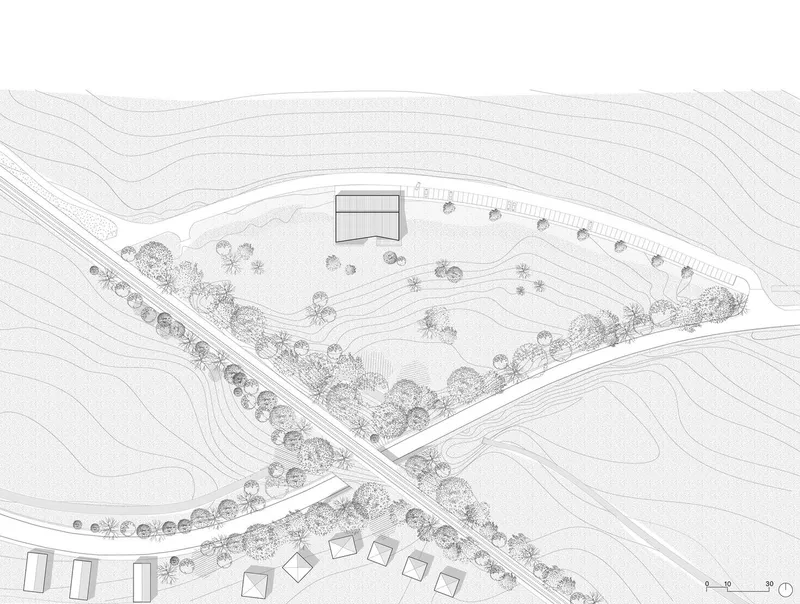 Site plan drawing showing a building and parking area surrounded by contour lines and landscaping