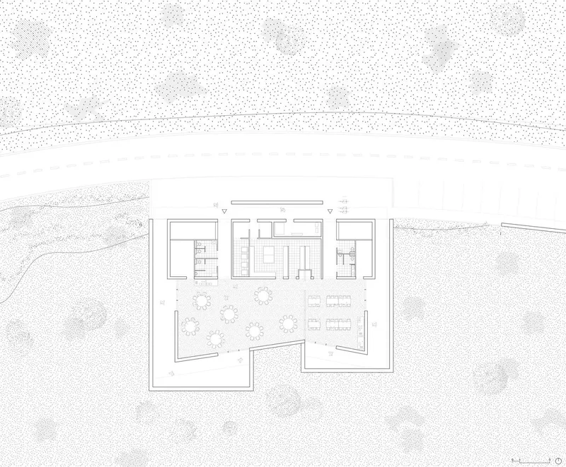 Site plan drawing showing rectangular volumes arranged around a central courtyard with trees