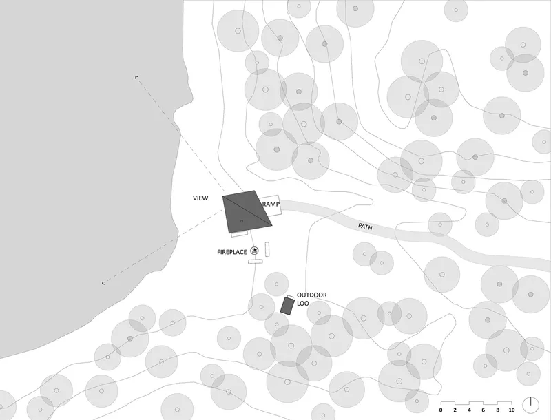 Site plan drawing showing the cabin footprint among trees with labeled outdoor features