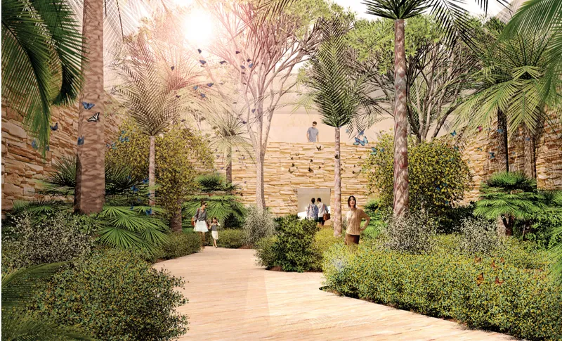 Garden courtyard with palm trees and planted beds framing a terraced stone wall
