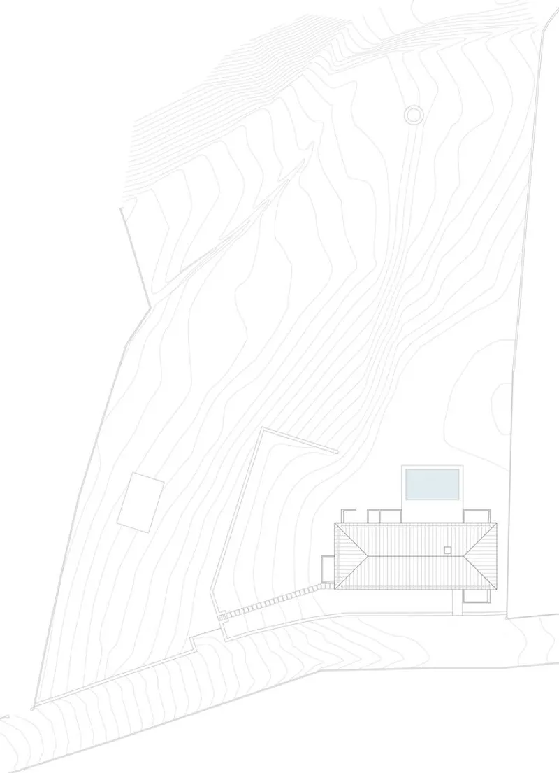 Site plan drawing showing the residence nestled within contour lines and scattered planting