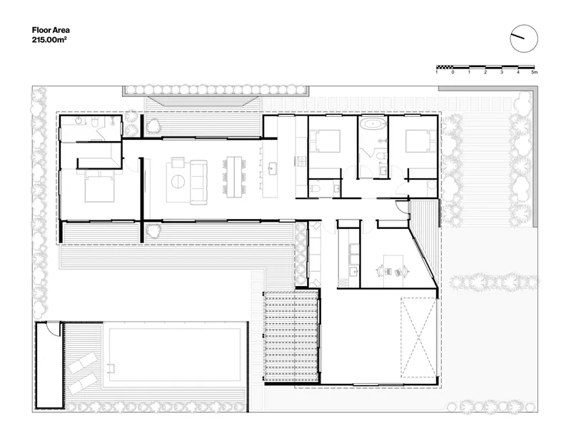 Floor plan drawing showing an L-shaped residence with bedrooms, open living areas, and courtyard spaces