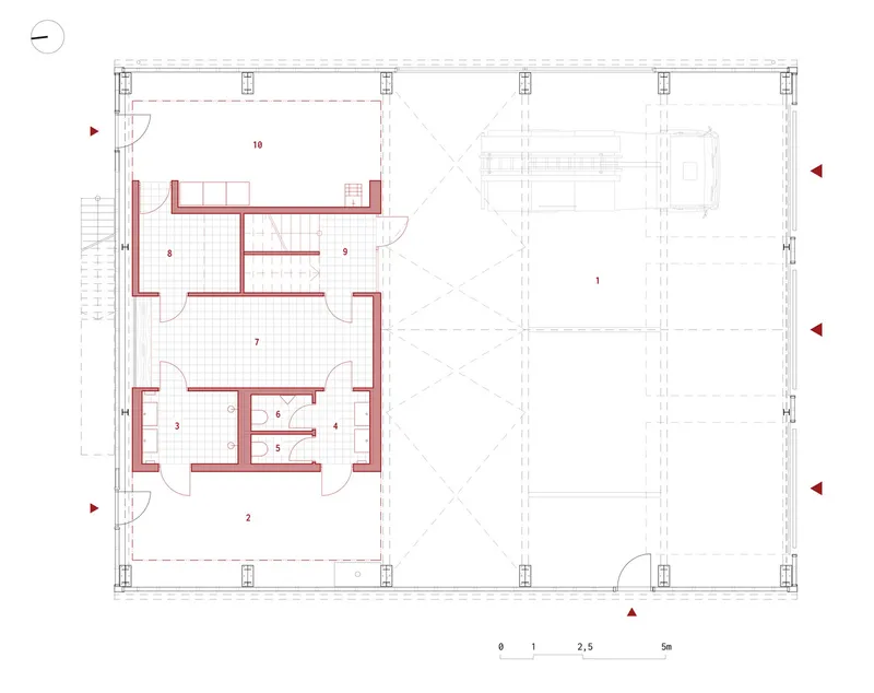 Floor plan drawing showing a compact residential unit and large adjacent hall with gridded structural columns