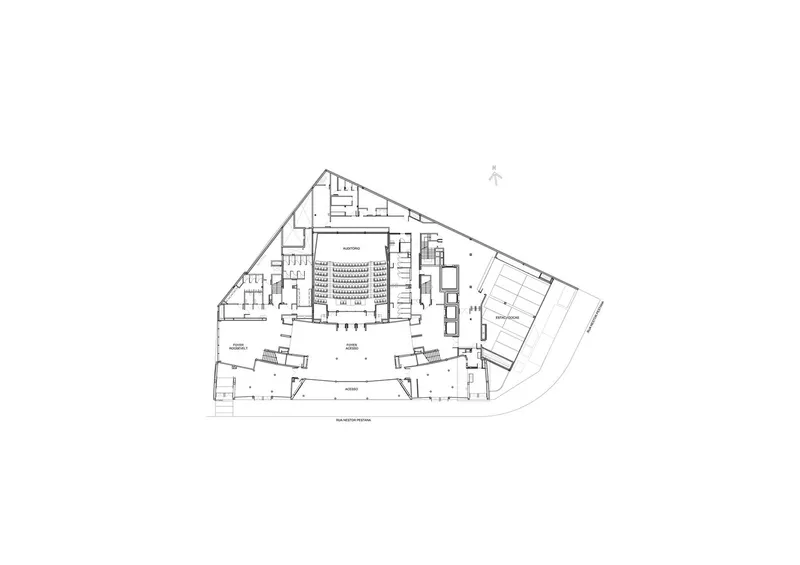 Ground floor plan revealing an open foyer with diagonal circulation paths converging at the central auditorium