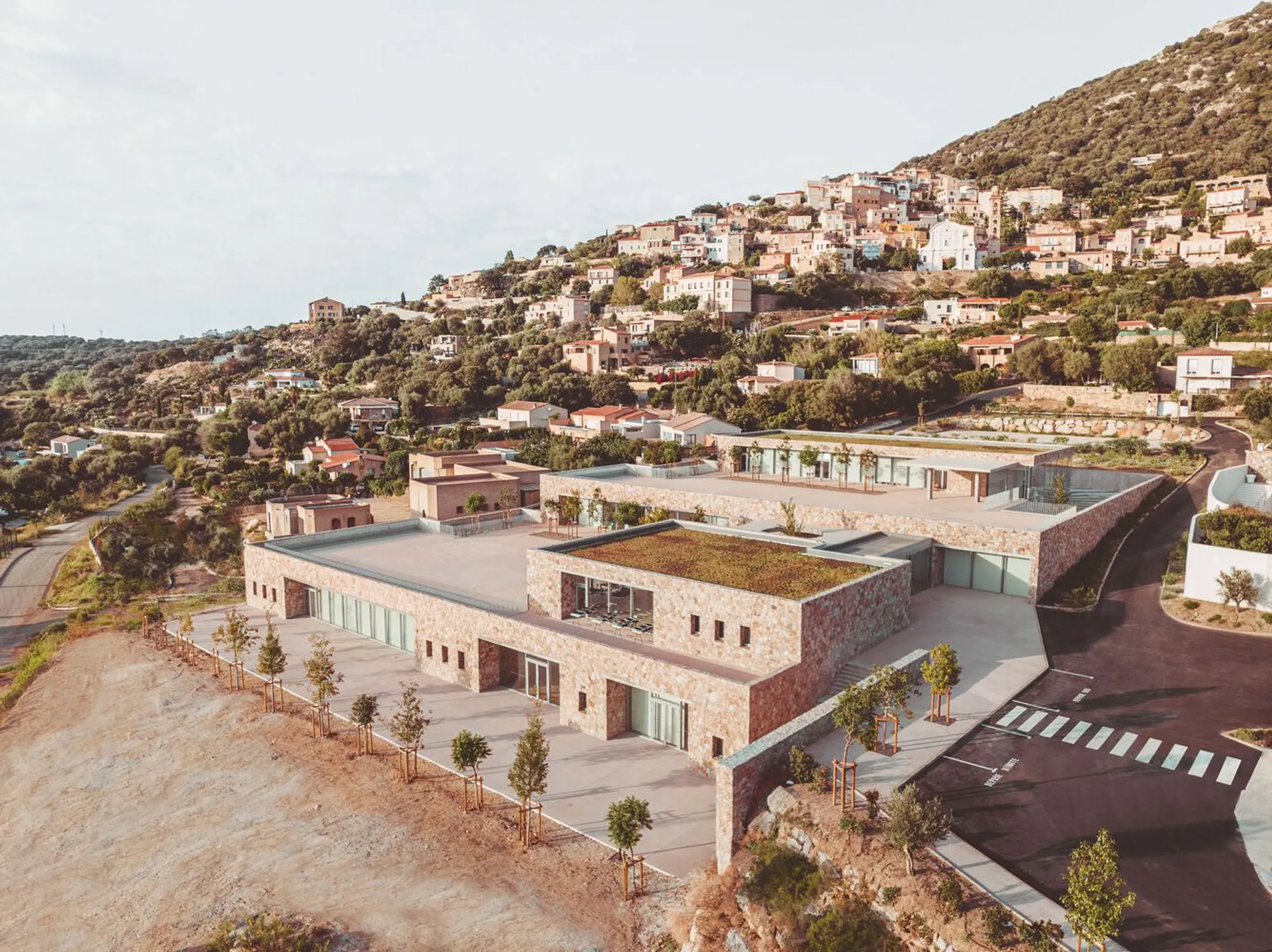 Amelia Tavella Terraces a School into the Corsican Hillside at Lumio