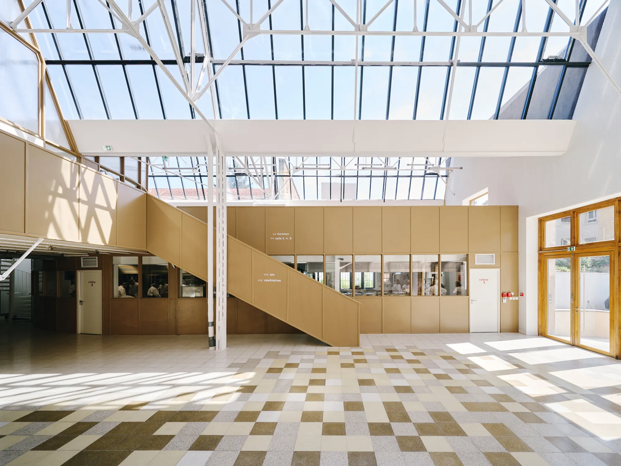 FREAKS Architecture Converts a Montreuil Taxi Garage into a Cooking School for Migrant Chefs