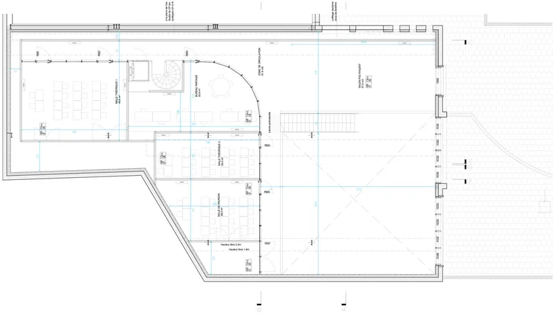 Floor plan drawing showing rectilinear spaces with curved partition and angled building perimeter