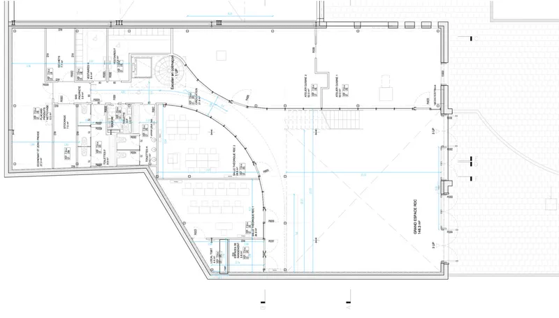 Floor plan drawing showing an angled L-shaped layout with curved wall and service zones