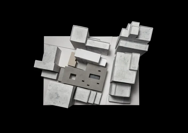 Axonometric model rendering revealing interior layout with central void and surrounding roofed volumes