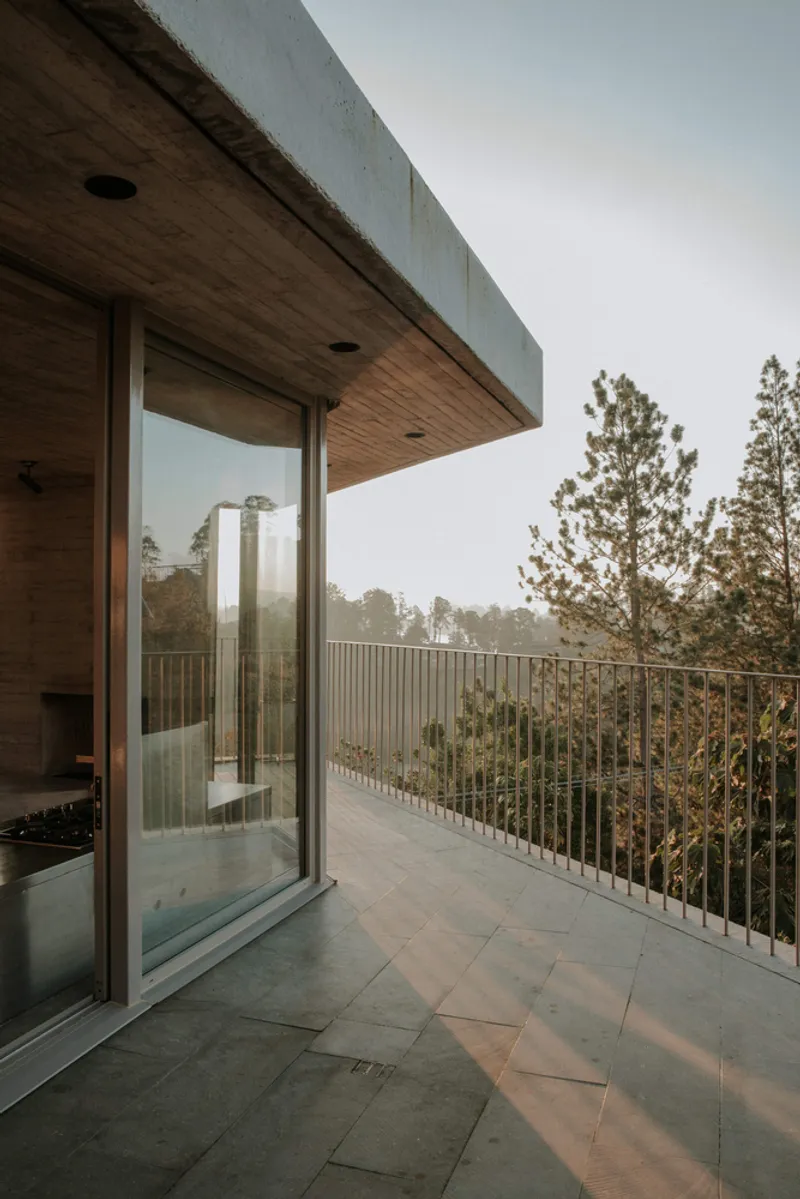Covered terrace with timber soffit and sliding glass door opening to vertical rod railing