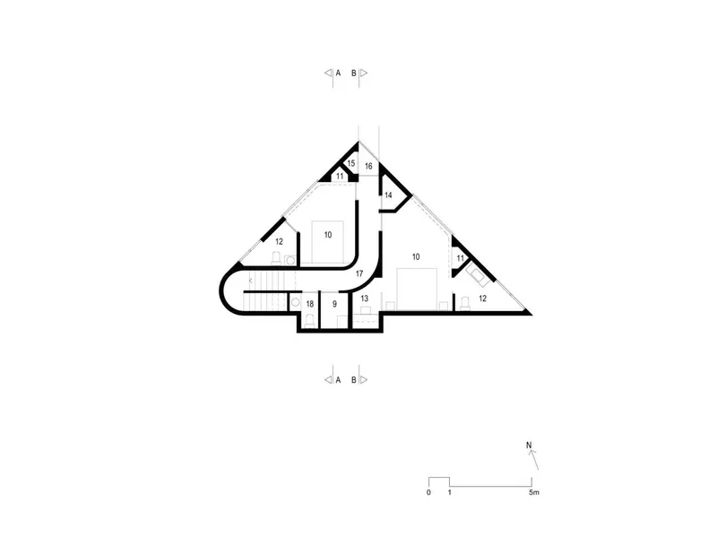 Floor plan drawing showing a triangular footprint with curved walls and numbered rooms