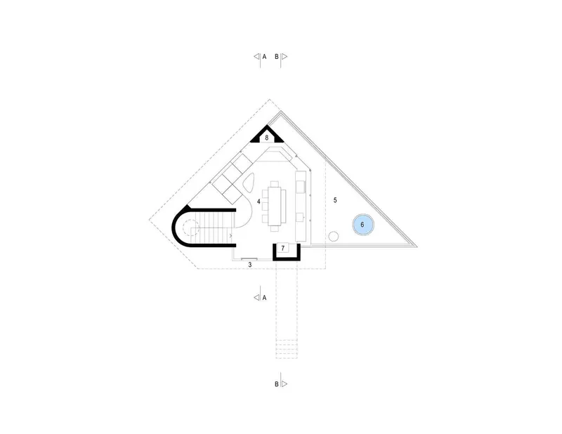 Floor plan drawing showing a triangular volume with curved entry and central staircase