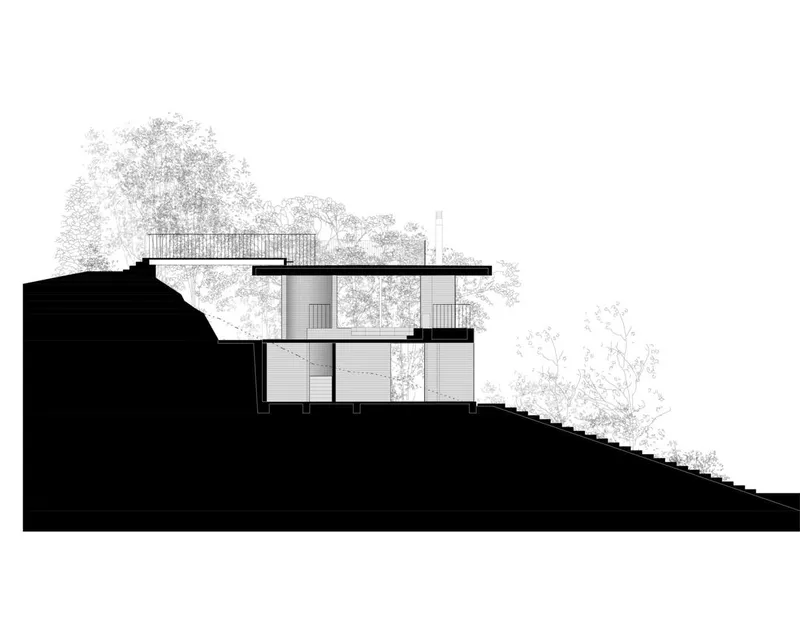 Section drawing showing a two-level structure embedded in sloping terrain with surrounding trees
