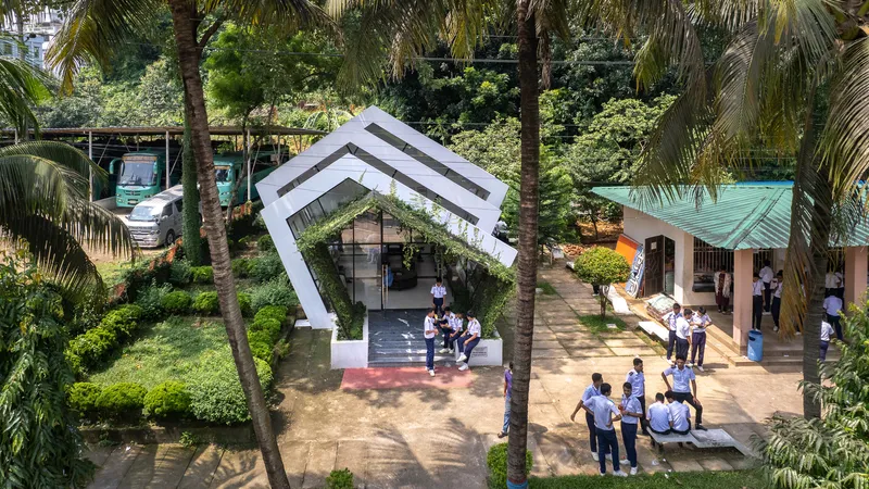 Aerial view of the white gabled pavilion surrounded by palm trees with visitors gathered below