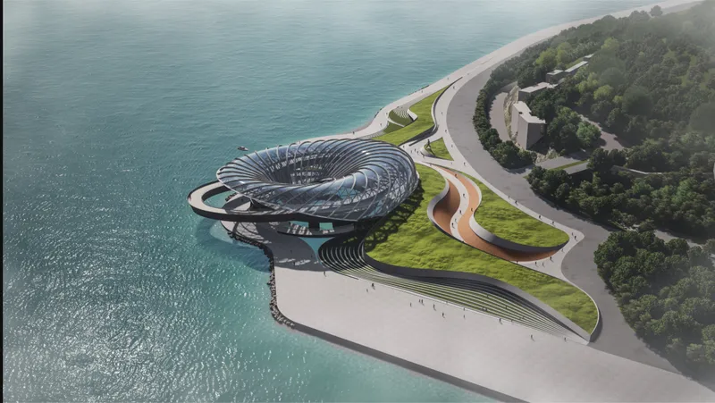 Aerial view of the organic ribbed structure jutting into the water with curved pathways and green roof
