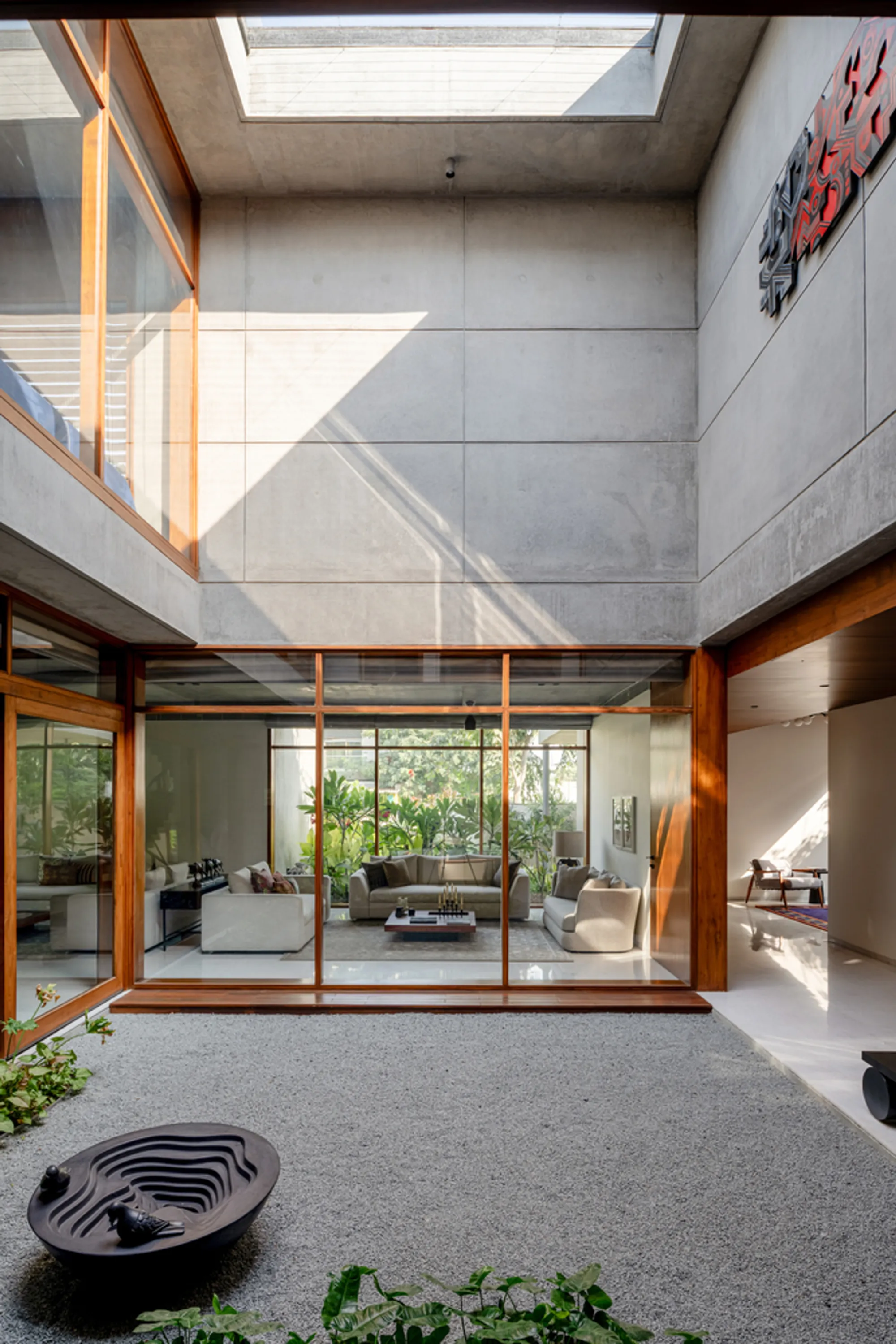 Modo Designs Organizes a Concrete Courtyard House Around Light, Air, and Garden Views in Ahmedabad