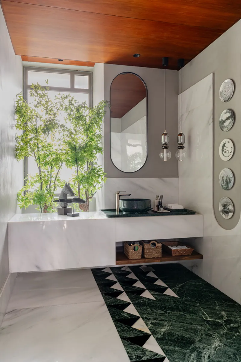 Powder room with floating vanity, timber ceiling and geometric black-and-white floor tiles meeting green marble