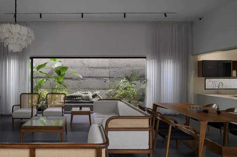Open living and dining area with horizontal window overlooking slatted screen wall and greenery